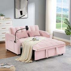 a living room with a pink couch and white rug