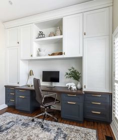 a home office with white cabinets and wood flooring, along with a rug on the floor