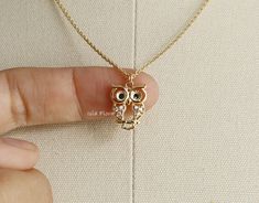 "Beautifully crafted Sitting Owl necklace, see through between the details of the Body and Face. CZ encrusted Wings and Black Rhinestones for Eyes, Super Cute and Dainty -18k Gold Dipped * Brass Casting * Lead & Nickel Free ◾ MEASURES * Necklace Length: 16\" plus 1.5\" adjustable chain * Pendant Width: 0.5\" * Pendant Height: 0.7\" * Closure: Lobster Claw ◾ CARE: * Treat delicately to extend its life. Clean only with a soft, dry cloth. * Chain/Pendants are gold plated so please avoid contact around water such as shower, pool, spa, etc. * Do not wear during sleep or workouts. * Avoid contact with chemicals, sweat, salts, and oils. Your jewelry will last a long time if you care for it properly. ◾ PLEASE NOTE: Business days do not include weekends & holidays, as the postal service does not op Jewelry Layering Necklace, Jewelry Layering, Owl Pendant Necklace, Owl Necklace, Owl Jewelry, Owl Pendant, Gold Dipped, Layering Necklace, Black Rhinestone