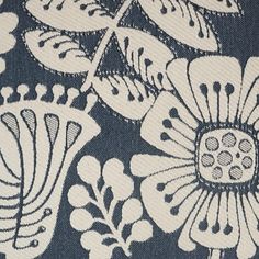 a blue and white floral print fabric with large, ornate flowers on the side of it