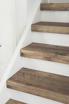 some wooden steps leading up to a glass table