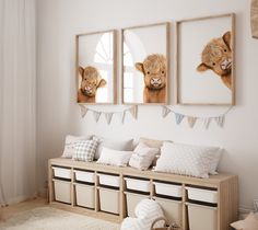 three framed pictures hang on the wall above a bench with storage bins underneath it