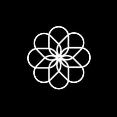 a black and white flower logo on a black background