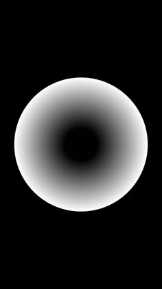 a black and white image of a circular object in the dark sky with only one light visible