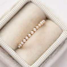 a ring with pearls is in a box