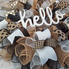 a wreath made out of burlocks with the word hello spelled on it and polka dots