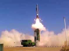 an army vehicle is launching a rocket into the sky