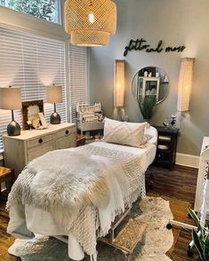 a bedroom with a bed, dressers and lamps in it's center area