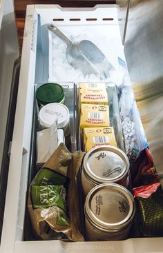 an open refrigerator filled with lots of food and condiments on top of it