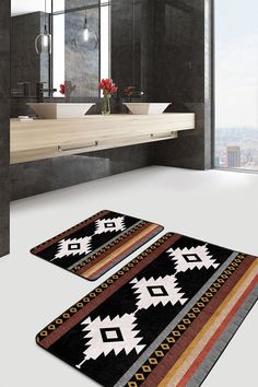 two bathroom rugs on the floor in front of a sink