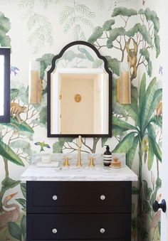 a bathroom with a mirror, sink and wallpaper