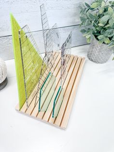 a small model sailboat sitting on top of a wooden board