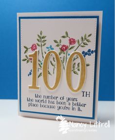 a handmade birthday card with the words 100th on it and flowers in gold