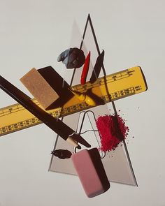 a pair of scissors, tape measure, and other items are on top of each other