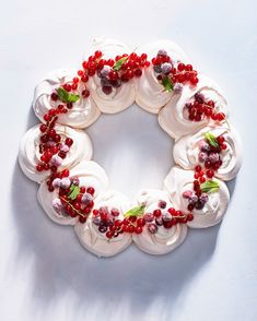 a cake decorated with white frosting and red berries