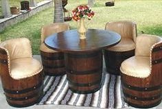 a table and chairs are set up on a striped rug in front of a grassy area