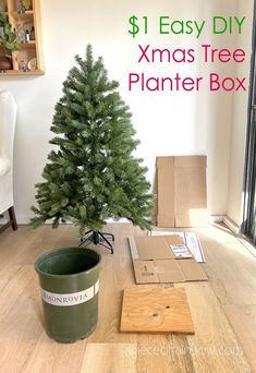 a christmas tree sitting on top of a wooden floor next to a planter box