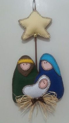 an ornament with two people and a star on it