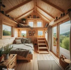 a loft with stairs leading up to the second floor and a bed on top of it