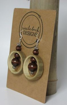 Bamboo earrings made from salvaged bamboo.  This pair includes wood and silver colored beads and silver hardware. The bamboo is sealed with Mod Podge and finished with clear, acrylic spray. Cheap Natural Wood Jewelry As A Gift, Wood And Bead Earrings, Coconut Jewelry, Bamboo Jewelry, Wood Jewelery, Bamboo Crafts, Bamboo Earrings, Bone Jewelry, Wire Crafts