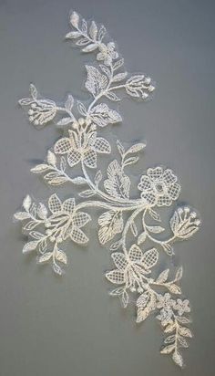 an embroidered lace design with leaves and flowers