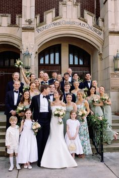 a large group of people standing in front of a building