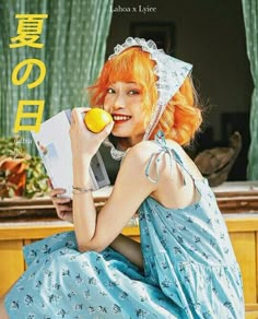 a woman with red hair is holding an apple and looking at the camera while sitting down