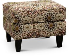 a small ottoman with an ornate pattern on it