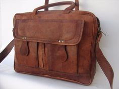 a brown leather briefcase sitting on top of a white table