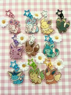 the pokemon pins are all in different colors and sizes, with daisies around them