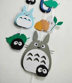 an assortment of paper cutouts with totoro and other cartoon characters on them