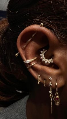 a woman wearing ear piercings and earrings