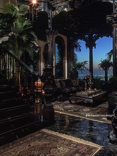 an elaborately decorated living room with stairs and chandeliers on the ceiling is lit by candles