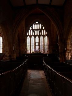 an empty church with pews and stained glass windows