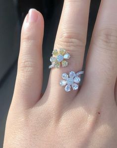 a woman's hand with two rings on it