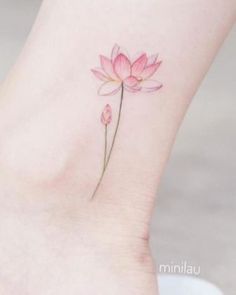 a small pink flower on the ankle tattoo by minilau tattoos and body art