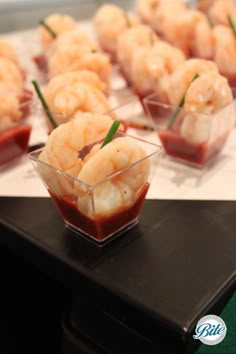 small plastic bowls filled with shrimp on top of a table