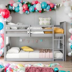 a bunk bed with balloons and streamers on the wall