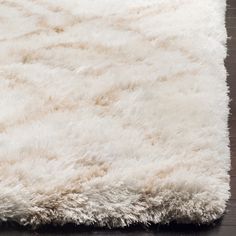 a white rug on top of a wooden floor