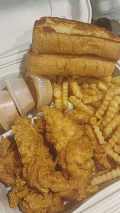 fried chicken and french fries are served in a container