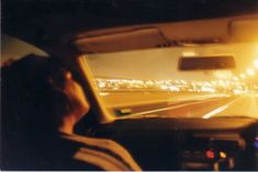 a man driving down a highway at night