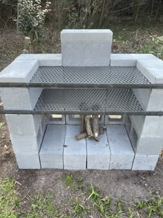 an outdoor fire pit made out of concrete blocks