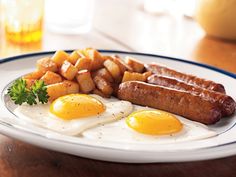 two eggs, sausage and potatoes on a plate with the words treat yourself to breakfast this week