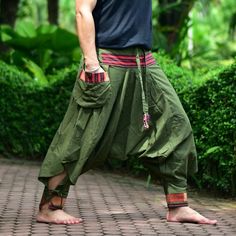 "Green Tribal pants, Hmong pants, Traditional Thai pants, Harem pants, Unisex pants Tribal pants is very comfortable and easy to wear, Unisex for Men and Women Every Detail of Tribal pants is made by Thai Craftsmanship. Tribal pants is inspired by Tribal in the North of Thailand or Hmong. Redesign for easy to wear and comfy. Great for many occasion activities like Chilling time, Casual wear, Relax time. This item is made of high-quality cotton in the north of Thailand. Printed with Special techn Harem Pants With Pockets For Festivals, Traditional Baggy Bottoms For Spring, Baggy Green Pants For Festival, Green Baggy Pants For Festival, Traditional Style Baggy Pants For Spring, Traditional Green Harem Pants With Loosely Fitted Hips, Traditional Baggy Pants For Spring, Festival Harem Pants With Pockets, Casual Pants With Pockets For Festivals