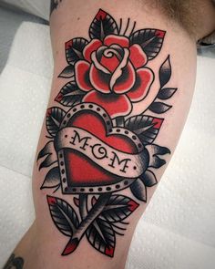 a tattoo with a heart and roses on it