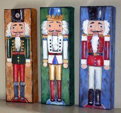 three wooden nutcrackers painted in different colors