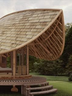 a large wooden structure sitting on top of a lush green field