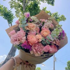 a person holding a bouquet of flowers in their hand