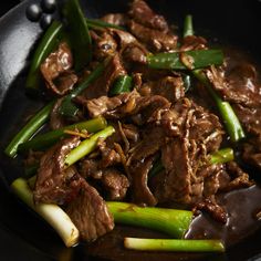 beef and asparagus stir fry in a skillet