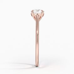 a rose gold ring with a single diamond